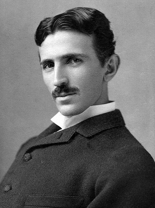 Black-and-white studio portrait of the historical Nikola Tesla, about age 34, photographed by Napoleon Sarony around 1890.